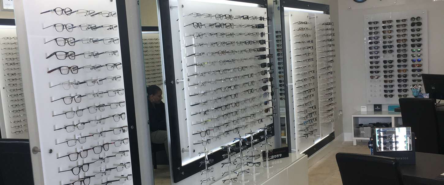Optical retail floor with wall displays and mid-room furniture